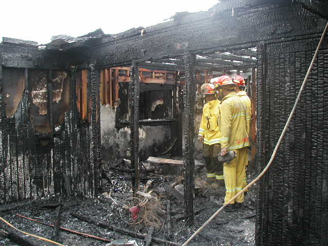 Arson Investigators in a burned out house.